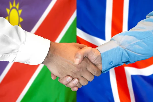 关于纳米比亚和冰岛国旗背景的握手. — 图库照片