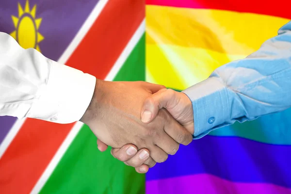 Stretta di mano su namibia e LGBT gay bandiera sfondo . — Foto Stock