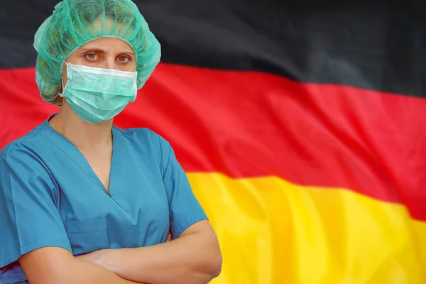Woman surgeon on the background of the Germany flag. Health care, surgery and medical concept in Germany.