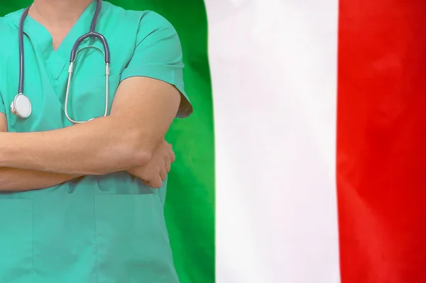 Male surgeon or doctor with stethoscope on the background of the Italy flag. Health care and medical concept. Surgery concept in Italy.