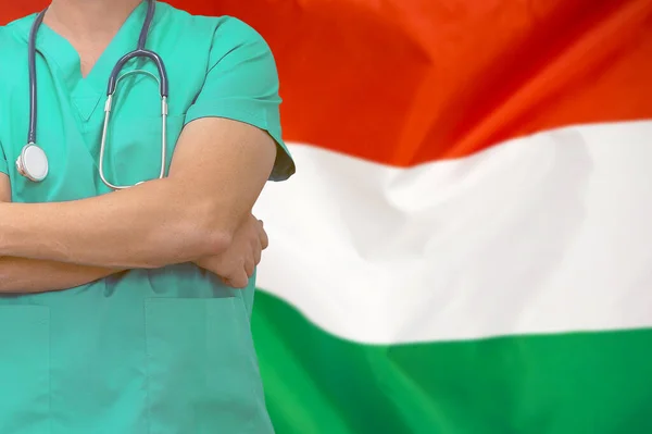 Male surgeon or doctor with stethoscope on the background of the Hungary flag. Health care and medical concept. Surgery concept in Hungary.