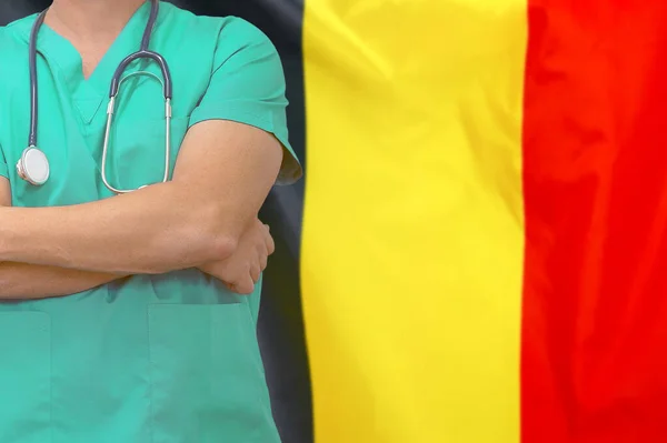 Male surgeon or doctor with stethoscope on the background of the Belgium flag. Health care and medical concept. Surgery concept in Belgium.