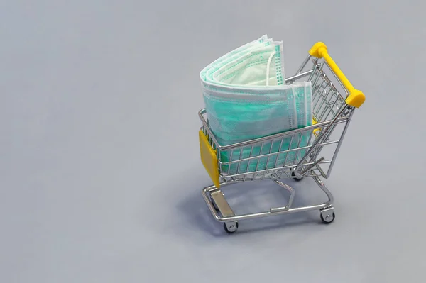 Protective Medical Masks Small Shopping Trolley Gray Background Panic Buying — Stock Photo, Image