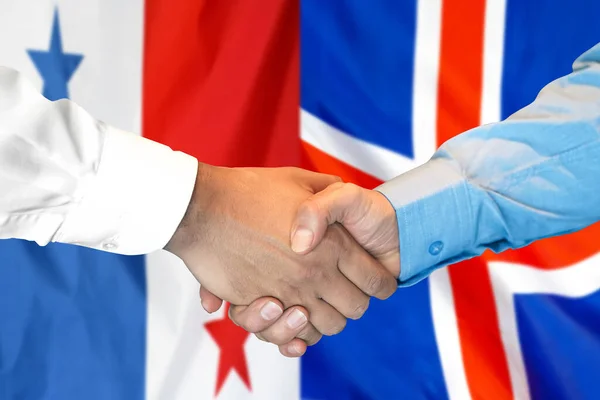 在两面旗帜的背景下进行商业握手 男子在巴拿马和冰岛国旗的背景下握手 支助概念 — 图库照片