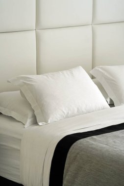 Luxury style bedding with puffy pillow in bedroom. Interior of a hotel bedroom. Modern bedroom interior in the hotel.