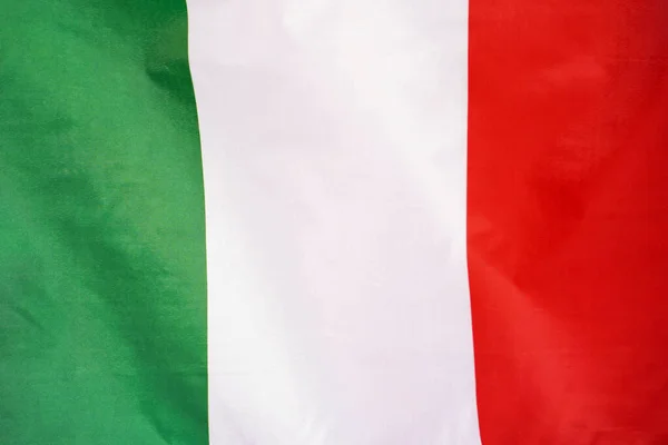 Fabric texture flag of Italy. Flag of Italy waving in the wind. Italy flag is depicted on a sports cloth fabric with many folds. Sport team banner.