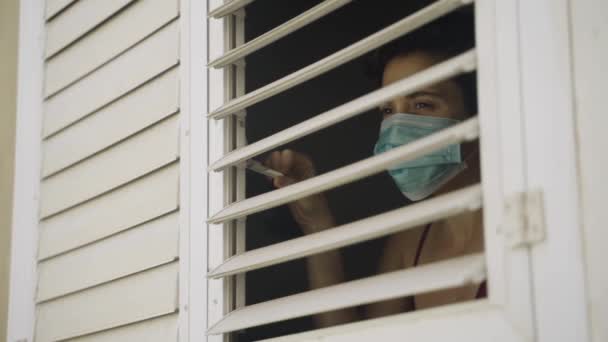 Young Woman Face Mask Looks Window Her House Closes Window — Stock Video