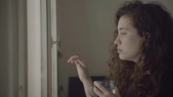 Woman Stuck Indoors Sad Face Puts Hand Window Glass — Stock Video