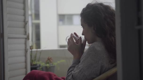 Woman Sips Mug Sitting Balcony Cold Day — Stock Video