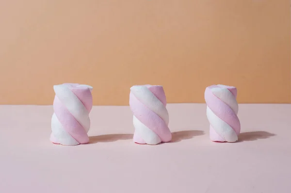 Três doces doces doces marshmallows brilhantes bonitos em rosa minimalista — Fotografia de Stock