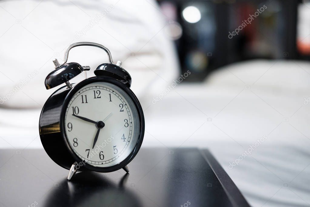 black alarm clock on the table