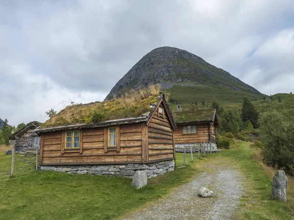 Traditional Scandinavian wooden cabins sod or turf roof house at a campsite in the Reinheim national Park. View from scenic road 63, Norway.