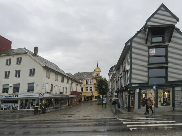 STAVANGER, NORUEGA, 9 de septiembre de 2019: calle con casas tradicionales de madera blanca en Gamle Stavanger. Gamle Stavanger es una zona histórica del centro de la ciudad de Stavanger. Día lluvioso y malhumorado. Viajes y — Foto de Stock