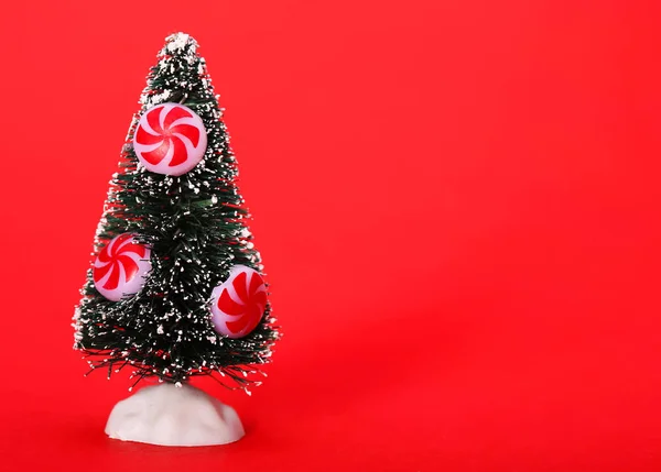 Christmas Tree with Peppermint Candy over red background — Stock Photo, Image