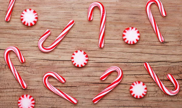 Christmas. Peppermint Candy and Canes on old wooden background Royalty Free Stock Photos