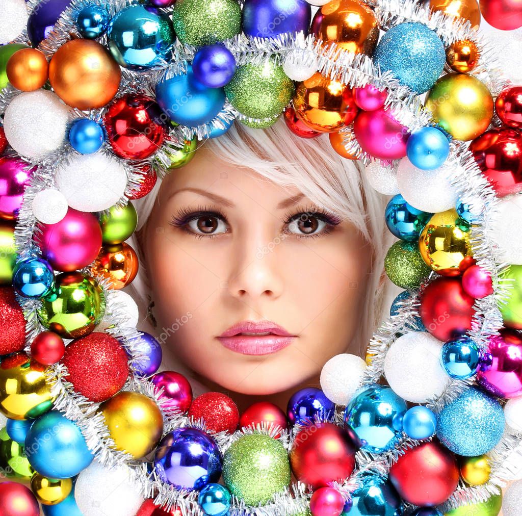 Christmas Woman with Colored Balls. Face of Beautiful Girl 