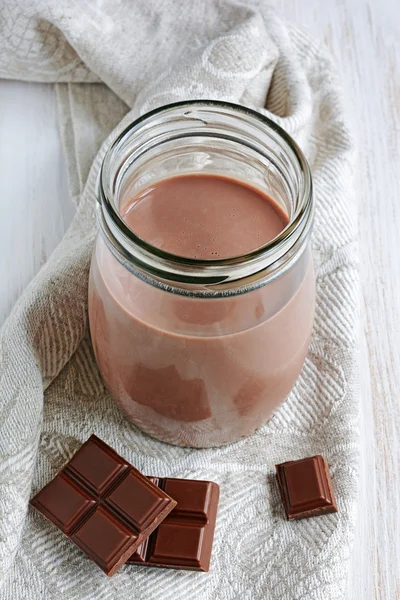 Chocolate milk with pieces of chocolate bar — Stock Photo, Image