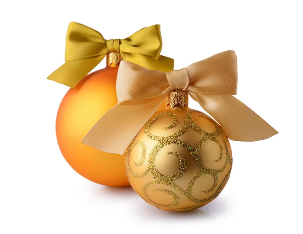 Golden Christmas balls with silk ribbon bows — Stock Photo, Image
