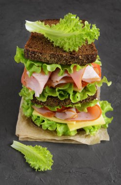 Çavdar ekmeği, jambon, domates, peynir ve marul ile sandviç 