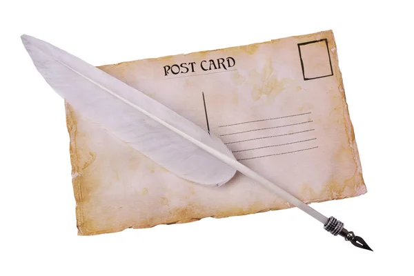 Old grunge postal card and feather pen — Stock Photo, Image