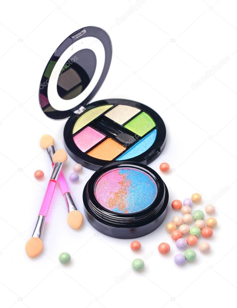 Composition of cosmetics with coloured eyeshadows, face powder balls and applicators
