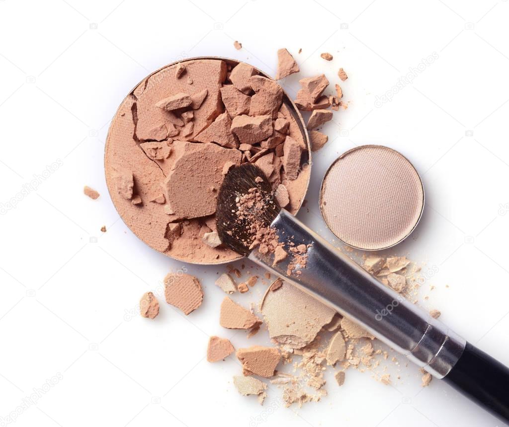 Round beige crashed face powder and eyeshadow with brush for makeup as sample of cosmetic product 