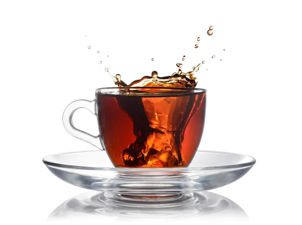 Splash in glass cup of black tea with ice — Stock Photo, Image