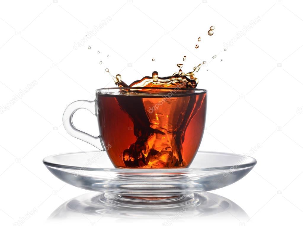 Splash in glass cup of black tea with ice