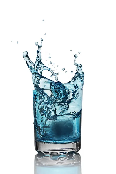 Splash in glass of blue alcoholic cocktail drink with ice cube — Stock Photo, Image