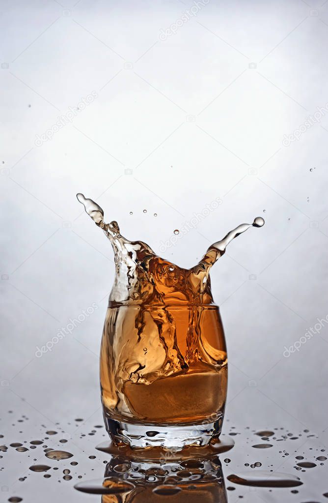 Splash in glass of scotch whiskey