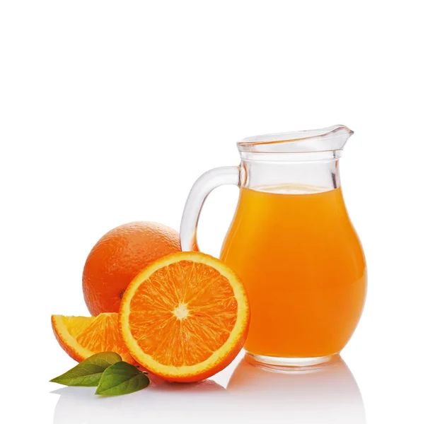 Glass jug of juice with slice of orange — Stock Photo, Image