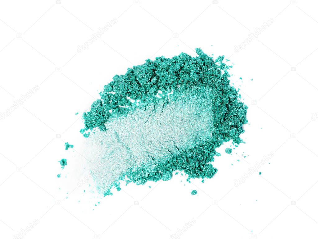 Smear of crushed teal eyeshadow as sample of cosmetic product