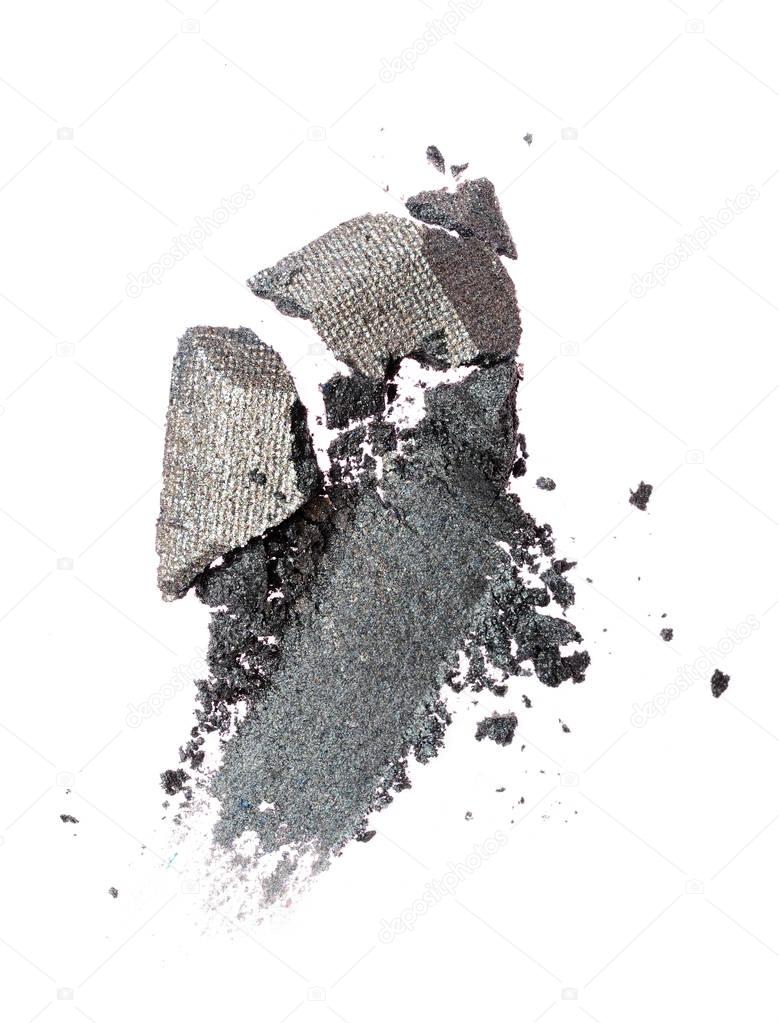 Smear of crushed shiny gray eyeshadow as sample of cosmetic product