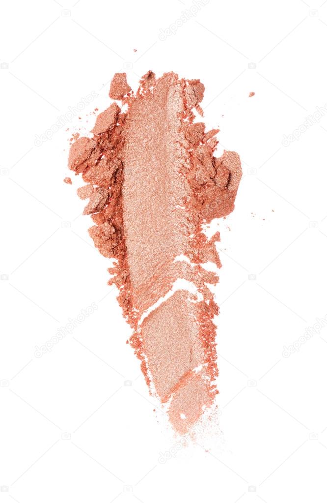 Smear of crushed beige eyeshadow as sample of cosmetic product isolated
