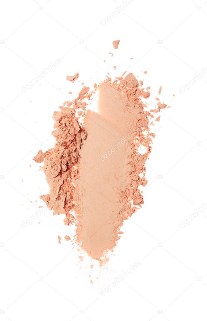 Smears of crushed beige face powder as sample of cosmetic product