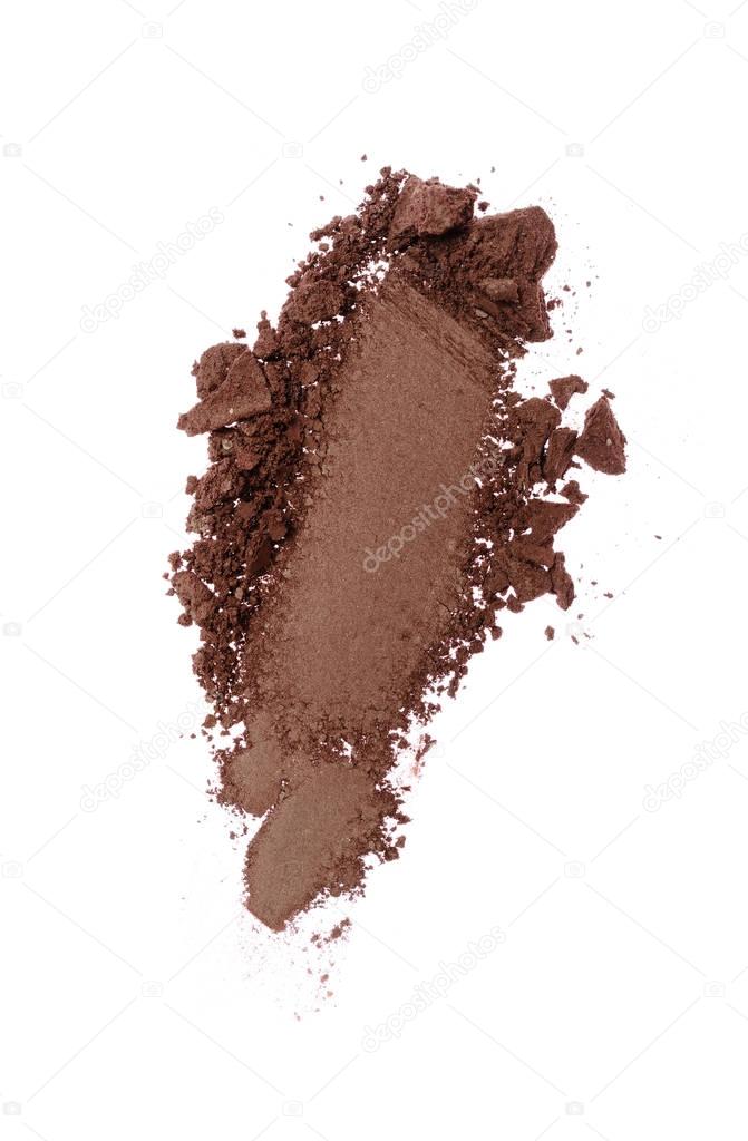 Smear of crushed brown eyeshadow as sample of cosmetic product
