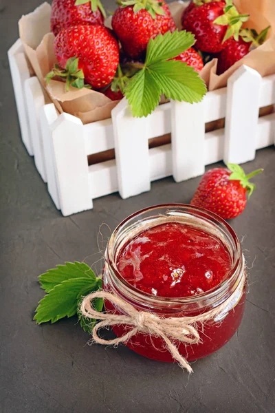 Ingredient for healthy breakfast. Homemade jam in open glass jar with fresh strawberry in white box — Stock Photo, Image
