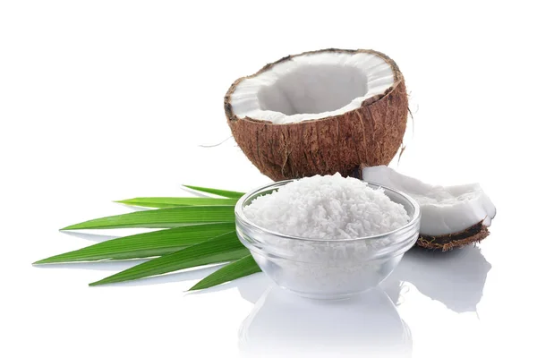Gesunde Ernährung. frische Kokosnuss mit Flocken im Glasteller und grünen Palmblättern — Stockfoto