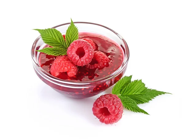 Close up view jam in glass bowl with fresh ripe raspberry and leaves — Stock Photo, Image