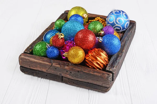 Винтажная деревянная коробка с цветными яркими рождественскими шарами — стоковое фото