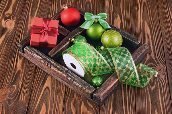 Vintage wooden box with Christmas tree balls, ribbon and gift box