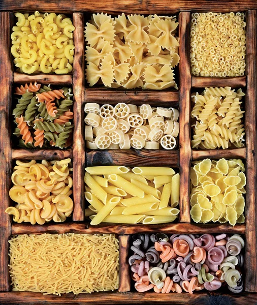 Traditional types and shapes of Italian pasta in vintage wooden box — Stock Photo, Image