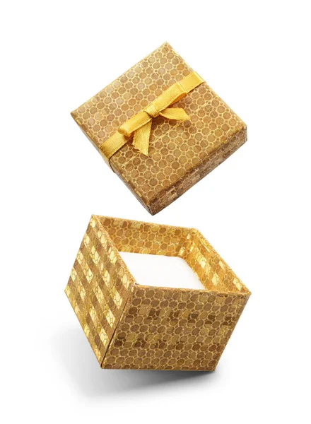 Golden flying open gift box with yellow satin bow — Stock Photo, Image