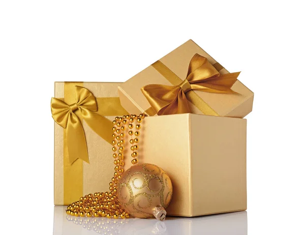 Golden classic gift boxes with satin bows, beaded garland and christmas ball Stock Image