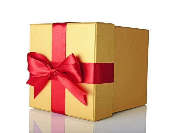 Golden classic shiny gift box with red satin bow — Stock Photo, Image