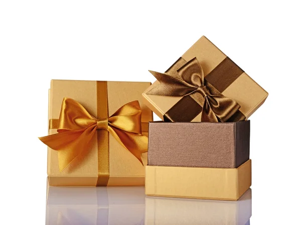Two golden classic shiny gift boxes with brown satin bows — Stock Photo, Image