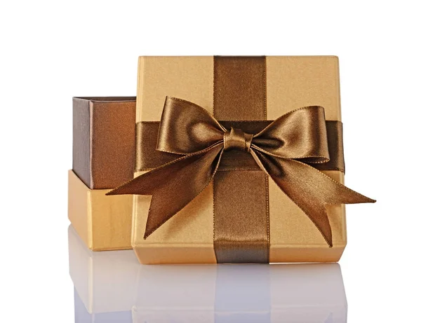 Golden classic shiny open gift box with brown satin bow Royalty Free Stock Images