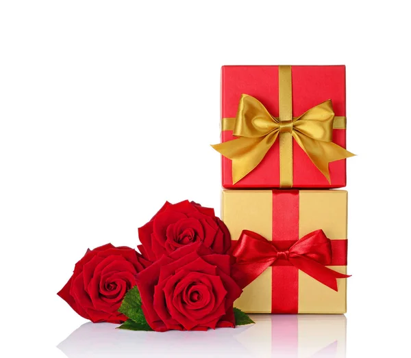 Golden and red classic gift boxes with satin bows and bouquet of roses — Stock Photo, Image