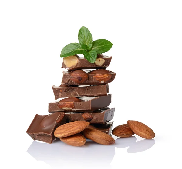 Close-up pieces of chocolate bar with whole almonds and mint — Stock Photo, Image