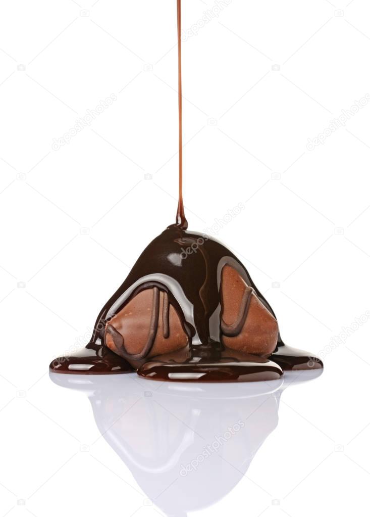 Close-up chocolate candy poured liquid black chocolate